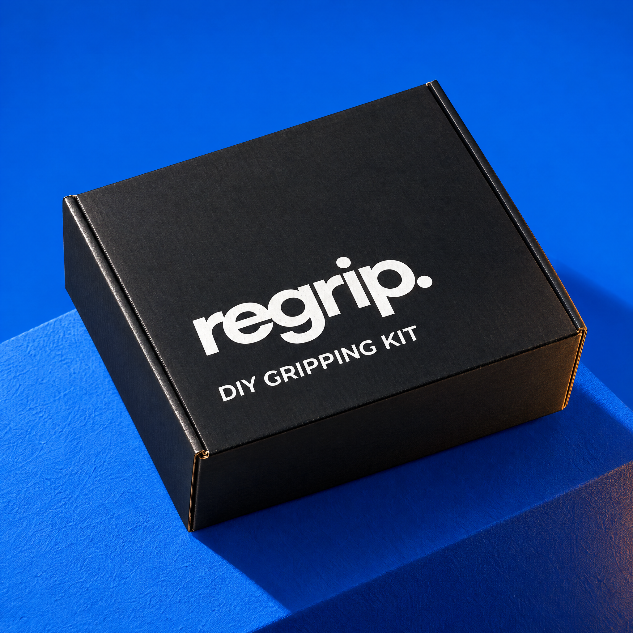 Black Regrip DIY Gripping Kit box on a cobalt blue display