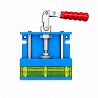Studio view of the Regrip gripping clamp with blue frame, red lever and green jaws on a white background